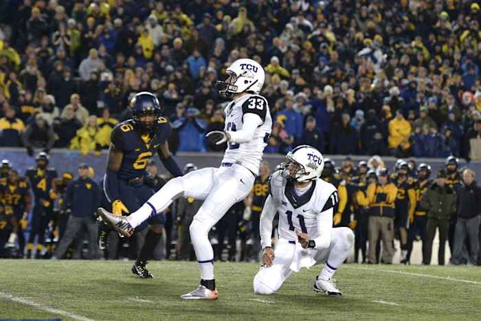 Nov 1, 2014; Morgantown, WV, USA; TCU Horned Frogs place kicker Jaden Oberkrom (33) kicks the game winning field goal as time expires in the fourth quarter against the West Virginia Mountaineers at Milan Puskar Stadium. TCU defeated West Virginia, 31-30.